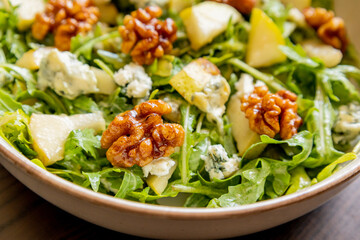 healthy fall salad with arugula pear cheese and candied walnuts