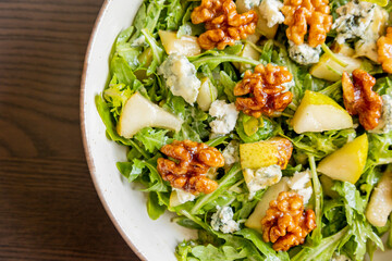 healthy fall salad with arugula pear cheese and candied walnuts