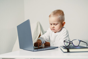 A Curious Baby Engaged with a Laptop showcases Modern Childhood in the Digital Age, where...