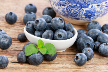 Blueberries on brown wooden table.