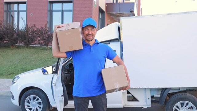 A courier with boxes near a white van preparing to leave for orders. Delivery concept, small business