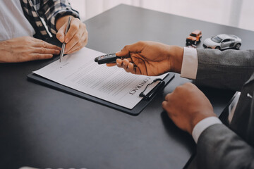 Car salesman gave the keys to the customers who signed the purchase contract legally, Successful...