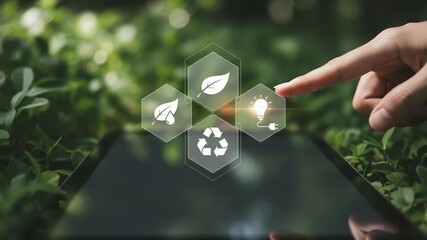 A hand touching a digital tablet displaying eco friendly icons on a background of green foliage - Powered by Adobe