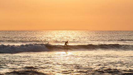 Fototapeta premium Surfer sihouette in the ocean on Bali, Sunset in the evening
