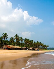 Tropical beach huts, ocean view, sunny day