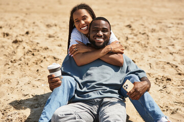 Loving couple enjoys a relaxed day at the beach with smiles and warm embraces