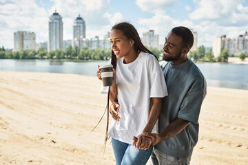 Young couple enjoys a delightful walk by the riverside under a sunny sky