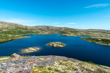 Naklejka premium landscape Russian North view in the tundra with a mountain river and a lake in the mountains
