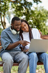 Young couple enjoying a romantic walk together while sharing smiles and laughter outdoors
