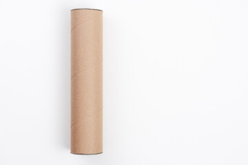 Long cardboard tube lying on white background