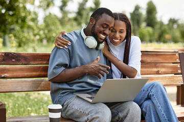 Young couple enjoys a joyful moment while exploring a peaceful park together