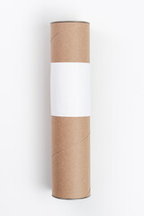 Cardboard tube with blank white label lying on white background