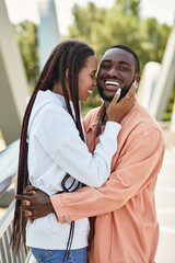 Young couple enjoys a romantic walk together in the park during a sunny afternoon