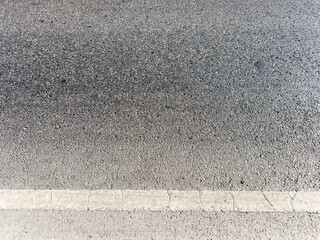 Fototapeta premium Asphalt road surface with old white line, high angle view