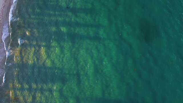 Amazing drone video of sunset rays shinning through aquamarine waters in Delray Beach Florida.