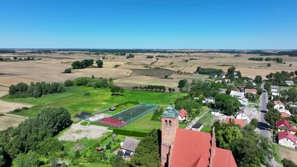 Aerial Piaseczno Poland Church Nativity 3. Northern Poland. Crops, wheat, barley, grain, potatoes and corn. Agricultural equipment. Vistula River, Lake, forest and farm rural area and landscape.