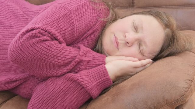 Overweight woman 50 sleeping on brown sofa during daytime, snoring, relaxed home environment, middle-aged, domestic scene, Daytime rest home showing natural sleep behavior mature woman, comfort zone