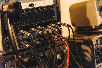 Vintage telephone switchboard with cables and handset
