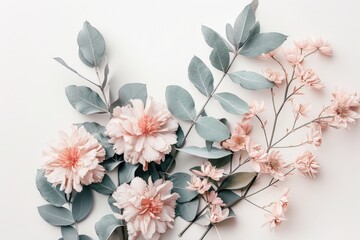 Fototapeta premium Delicate arrangement of pastel pink flowers and soft grey-green leaves on a white background, creating a serene and romantic aesthetic.