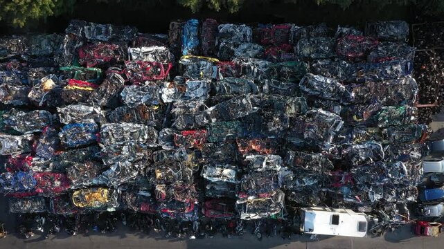 Aerial view of crushed cars and scrap metal create a mosaic of textures and colors in a recycling yard, reflecting industrial activity, Ghent, Flanders, Belgium.