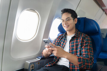 Waist up image of a fun Influencer man in an airline live while talking on a cell phone.