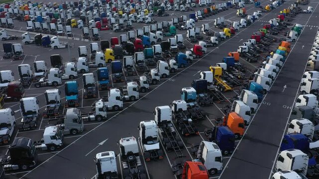 Aerial view of a vast parking lot filled with countless colorful trucks, creating a mosaic of transportation and logistics, Ghent, Flanders, Belgium.