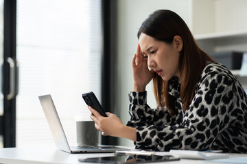 Tired asian businesswoman with headache at office, feeling sick at work.