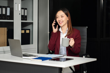 Business woman asian talking phones update plan working on laptop computers, online business.