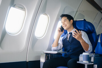 Confident businessman making a call in first class, enjoying comfort and connectivity during an...