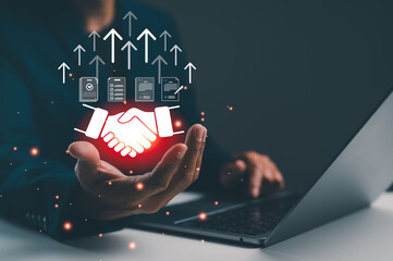 A person extends a hand in a business setting, symbolizing partnership, growth, and digital engagement, with graphical elements illustrating progress and collaboration.