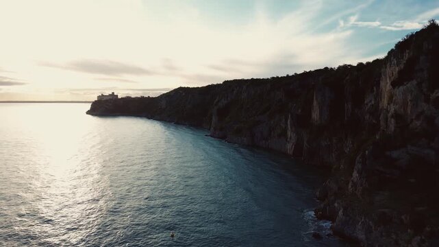 Aerial footage of the coastline with massive cliffs, Castello di Duino, Italy 4k