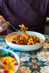 Man eating a bowl of casarecce pasta at a restaurant in Perth, Western Australia