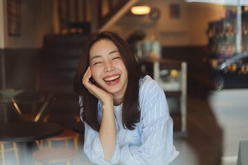 Portrait Cheerful Asian woman smiling at modern cafe, representing freelance lifestyle, digital...