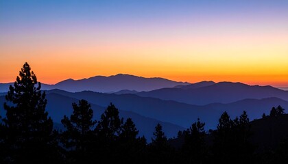 Obraz premium Dramatic Twilight Sunset with Tree Silhouettes and Mountain Range Under a Beautiful Gradient Sky of Orange and Blue Colors Stretching Across the Horizon for Scenic Landscape Backgrounds 