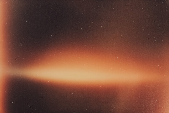 light leak overlay effect with scratch dust and orange light leaks,retro noisy film texture light leak flare on black background,grunge film burn texture with light leaks,old film strip
