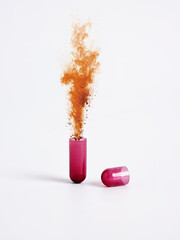 Open capsule releasing brown powder on white background