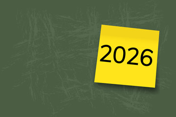 2026. goals. plan. new year. A yellow sticky note with the number “2026” written in bold black font, placed on a squared notebook paper background.