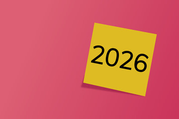 2026. goals. plan. new year. A yellow sticky note with the number “2026” written in bold black font, placed on a squared notebook paper background.