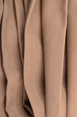 JAKARTA, INDONESIA - JANUARY 6, 2026: A roll of coyote tan ripstop fabric prepared for the...