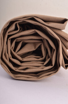 JAKARTA, INDONESIA - JANUARY 6, 2026: A roll of coyote tan ripstop fabric prepared for the production of outdoor military-style clothing.