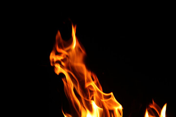 Close up burning flames on black background for graphic design or wallpaper.
