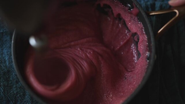 Whipping semolina mousse with electric hand mixer.