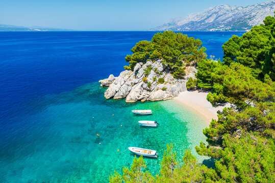 Makarska, Croatia. Crystal-clear turquoise waters and white pebble beaches in small bay of Punta Rata, Brela.