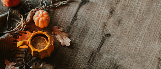 Cozy Autumn Setting with Pumpkin Mug and Seasonal Decorative Elements
