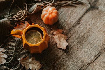 Cozy Autumn Setting with Pumpkin Mug and Seasonal Decorative Elements