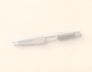 White ballpoint pen isolated on a light-colored surface