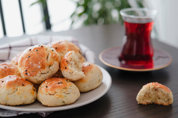 homemade turkish savory pastry pogaca with dill and black sesame or cumin, served with tea for...