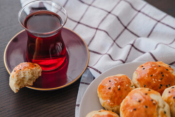 homemade turkish savory pastry pogaca with dill and black sesame or cumin, served with tea for breakfast or noon break