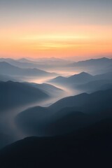 Misty mountains under soft sunrise create tranquil and breathtak
