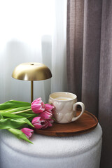 Cup with cappuccino, spring flowers tulips, morning concept, woman's day, bedroom design, gold modern desk lamp